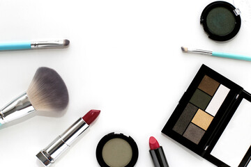 Makeup products: eye shadow, bright pink and red lipstick, cosmetic brushes on a white background. Decorative cosmetics.
