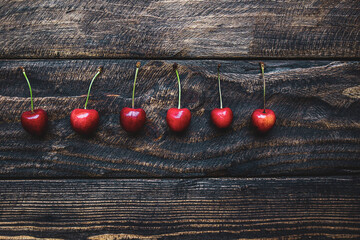 creative background of cherries on wooden background