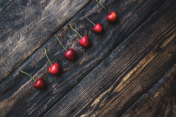 creative background of cherries on wooden background