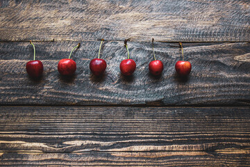 creative background of cherries on wooden background