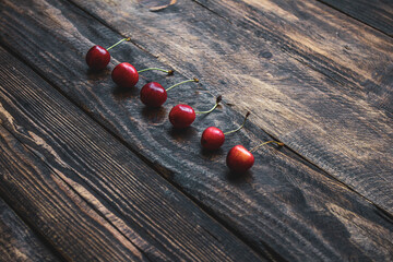 creative background of cherries on wooden background
