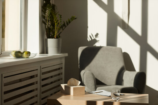 Image Of Empty Office Of Psychologist With Armchair And Table With Napkins And Documents