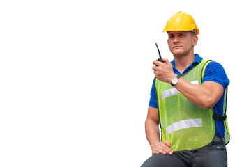 A man ware the yellow helmet and green reflection vest holding the walkie talkie in his hand isolated on white background