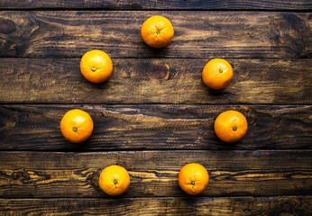 many oranges on wooden background