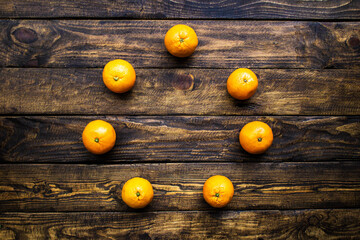 many oranges on wooden background