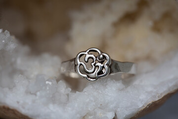 Silver metal ring in the shape of om