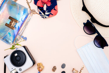 summer travel accessories. women's set of adult toys, camera, hat, glasses, protective mask and gloves on a light background. space for your text