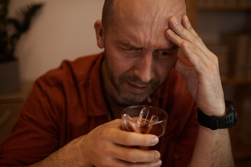 Drunk mature man drinking alcohol and getting rid of his problems with this way