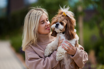 Portrait of a beautiful woman with a cute shih tzu dog.