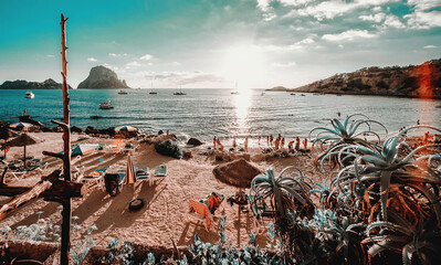 View of Cala d'Hort Beach in Ibiza. Unrecognizable tourists relaxing hanging out on the picturesque...