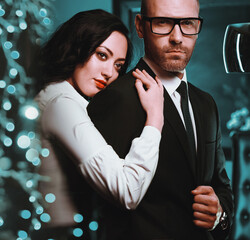 Couple indoors. Sensual brunette and handsome businessman
