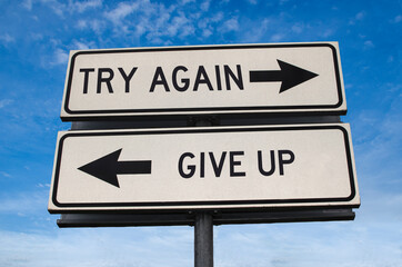 Try again vs give up. White two street signs with arrow on metal pole with word. Directional road....