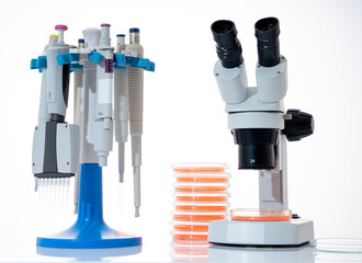 microscope, petri dishes and pipette stand by microbiological laboratory