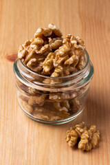 walnuts in a small glass on a wooden table