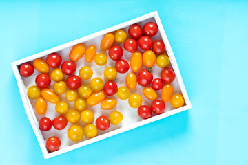 Top view of cherry tomatoes in small wooden crate