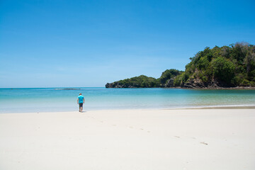 man walking on beautiful beach and tropical sea at lipe island ,satun Thailand