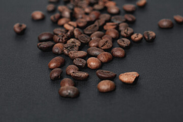 Coffee in beans on dark background. Coffee beans texture. Food background of coffee beans