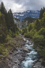 Fototapeta na wymiar Mountain valley in Switzerland with waterfalls and mountain stream