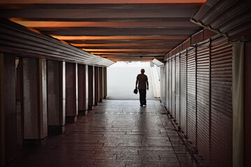 A man goes through an underpass.