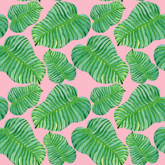 Tropical green leaves seamless pattern on a pink background.