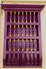 Colorful window with wooden bars