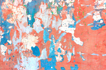Old concrete wall covered with colorful paint.