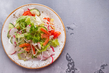 Fresh vegetables salad o a plate. Healthy food concept. Top view, text space