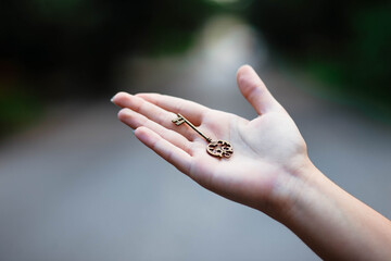 Hand with antique skeleton key. The key in a human hand. Old key in human hands.