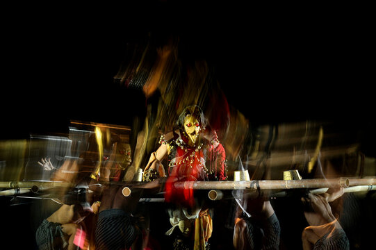 Javanese culture art dancer chicken mask face in multi exposure shot with dark background