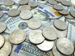Dollar bills and quarter dollar coins on white background