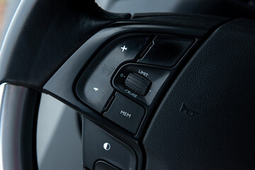 Obraz na płótnie Canvas Cruise control button on the steering wheel in car.