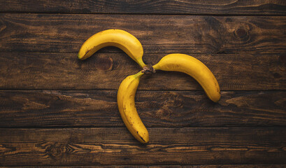yellow bananas on wooden table