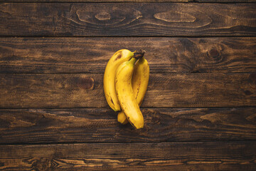 yellow bananas on wooden table