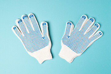 Pair if work gloves isolated on blue background