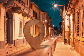 Street at Limassol old town with giant location pin. !!!Note for reviewer: Object in the middle of the photo is a self modelled 3d object placed on the image and does not require any kind of relase!!!