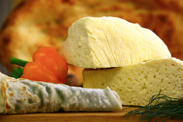 Traditional white cheese on the wooden board