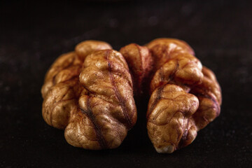Walnut peeled close-up on dark background