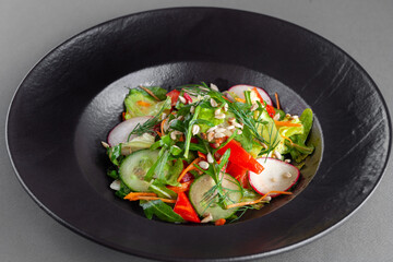 Fresh vegetable salad, tomato, cucumber, radish, lettuce, herbs
