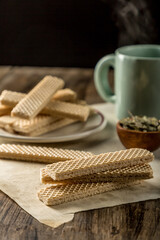 Heap of wafers in plate on an old wooden table