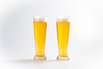 Cold fresh beer in two glasses with foam