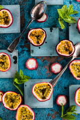 top view of fresh ripe delicious passion fruits with mint leaves