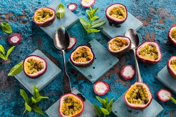 top view of fresh ripe delicious passion fruits with mint leaves