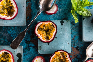 top view of fresh ripe delicious passion fruits with mint leaves