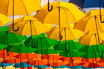 Fototapeta na wymiar Brightly colored hanging umbrella as a tropical summer theme decoration