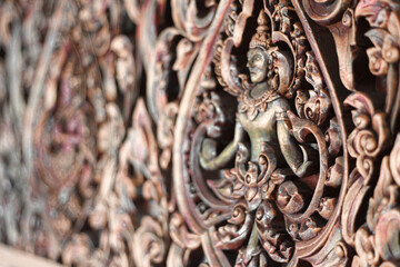 Elaborate traditional thai wall design of an Apsara Dancer in Wat Arun temple in Bangkok, Thailand