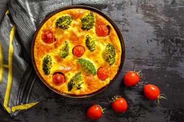 Homemade tart with broccoli, tomatoes in pan. Vegetarian food