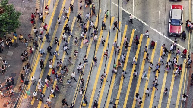 TL/ Asia, China, Hong Kong, Time lapse of people crossing the road using Pedestrian crossing in central shopping district during evening rush hour, aerial view