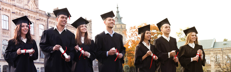 Happy students with diplomas near campus. Banner design - obrazy, fototapety, plakaty
