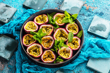 top view of fresh ripe delicious passion fruits with mint leaves