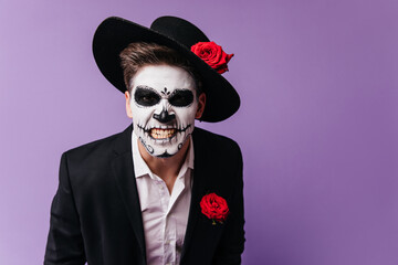 Scary guy in zombie outfit expressing rage. Studio photo of man in muertos costume fooling around...